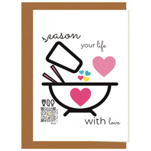 Season your life with love recycled paper singing greeting card seen with craft paper envelope behind it; illustration features bowl with heart in center being filled by salt shaker full of the word love and hearts pouring from it, qr code plays song