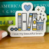 diecut sticker with books, heart and i love my beautiful brain type and qr code that plays song