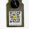 back of enamel overall pin showing qr code that plays overall song