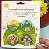smile songs pinback buttons that sing photograph of pack of four pinback buttons with qr codes on art that sings and colorful characters. features pink mountain girl; purple mountain man, blue happy camper and yellow flower child pin