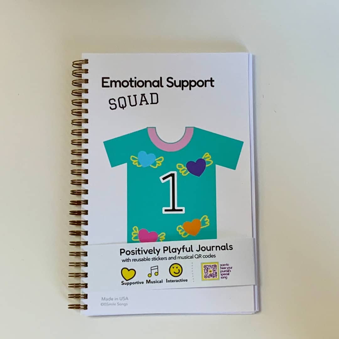 Emotional Support Squad interactive journal with cover featuring team jersey with number 1 and flying hearts, bellyband with QR code that sings song about what the journal is and does