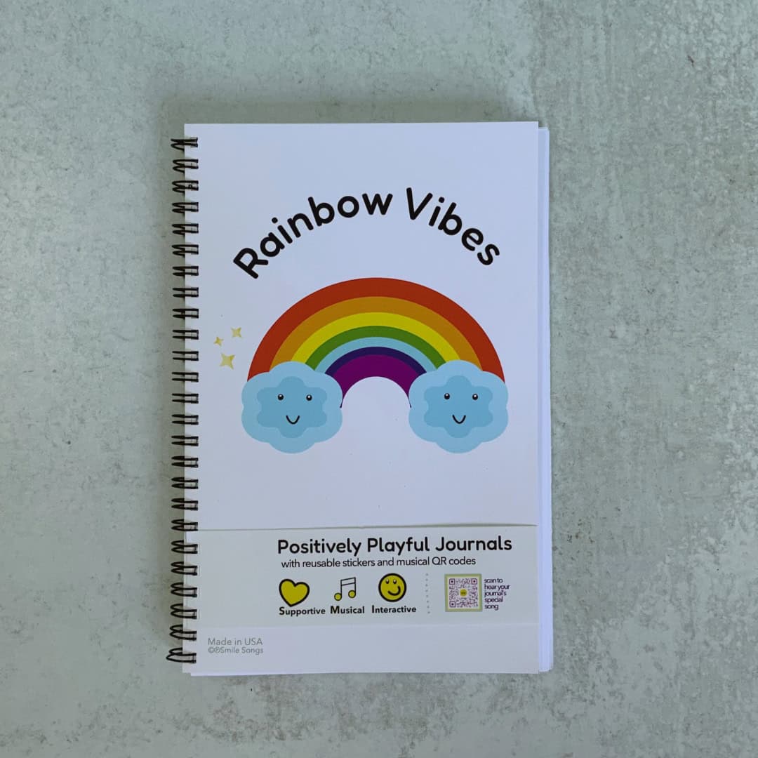 cover of rainbow vibes journal with rainbow and clouds